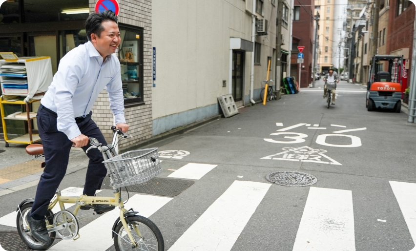 尾形地所のメンバーが自転車で駆けつける写真